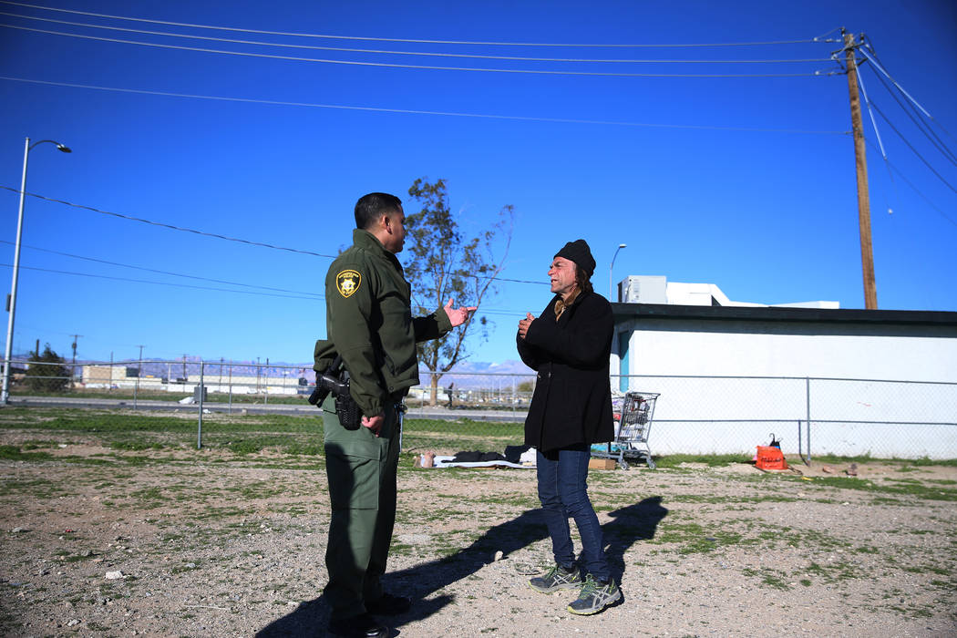 Las Vegas police officer Angel Nunez speaks with homeless man Charles Whritenour about services ...