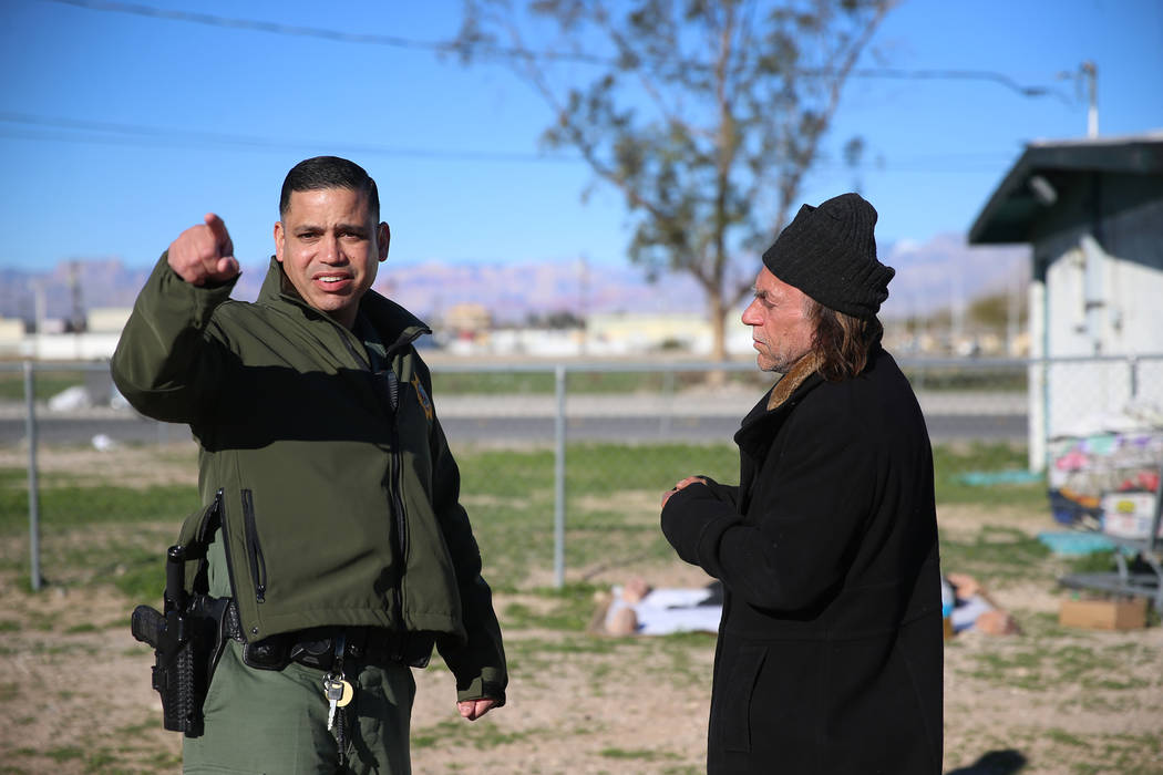 Las Vegas police officer Angel Nunez speaks with homeless man Charles Whritenour about services ...