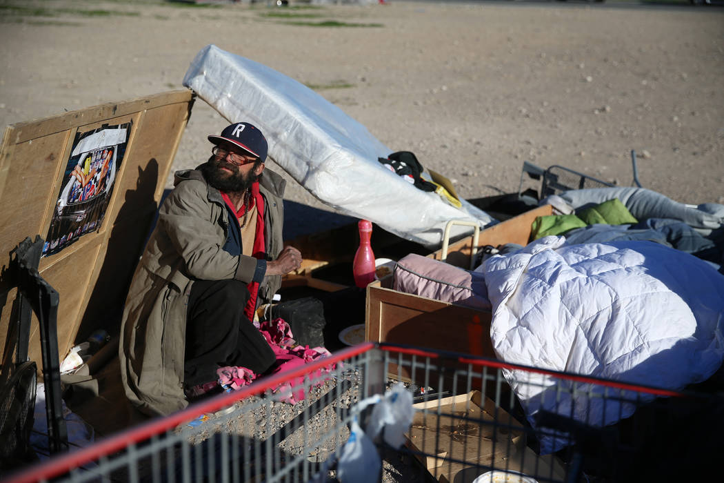 Homeless man Anthony Muratore sits on the floor with his belongings near the intersection of W ...