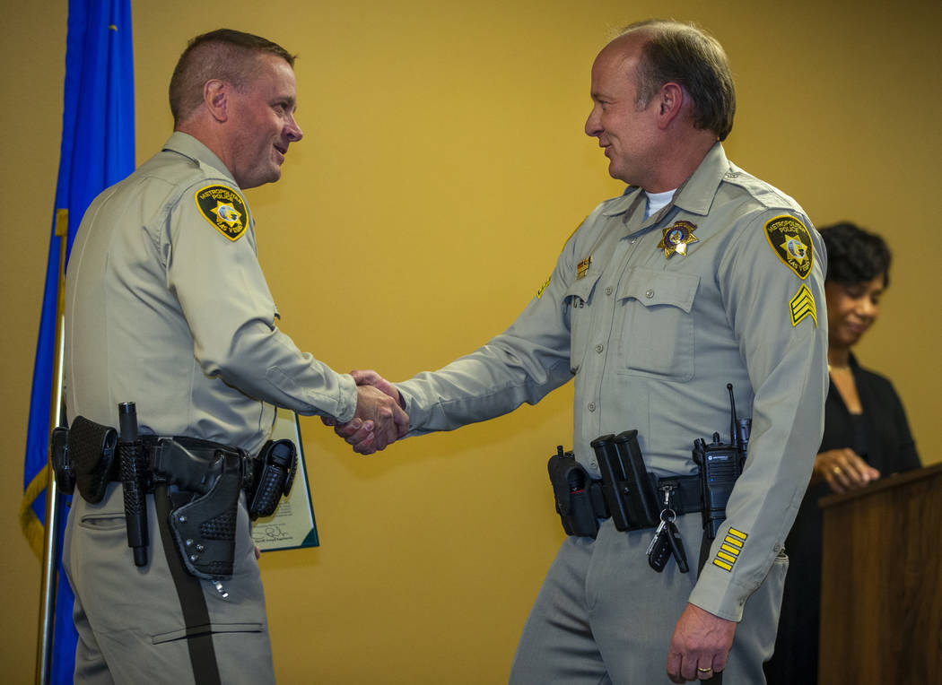 Undersheriff Kevin McMahill shakes the hand of Sgt. Paul McCullough, receiving a unit exemplary ...