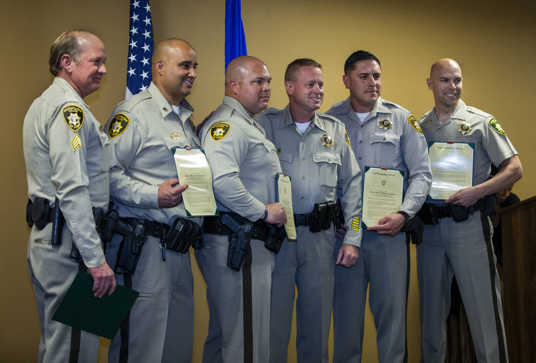 Collision investigative team officers receiving a unit exemplary award stand with Undersheriff ...