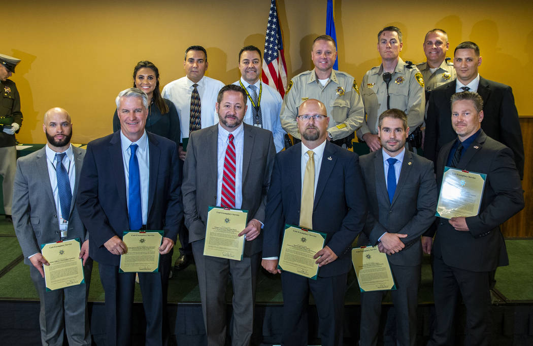Members of the "1 October ballistics team" receive a unit exemplary award from Undersheriff Kev ...
