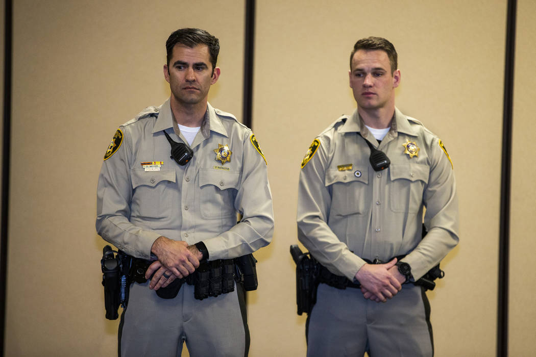 Officers Dennis Moyer and Kevin Moss ready to receive a lifesaving award during a Metropolitan ...