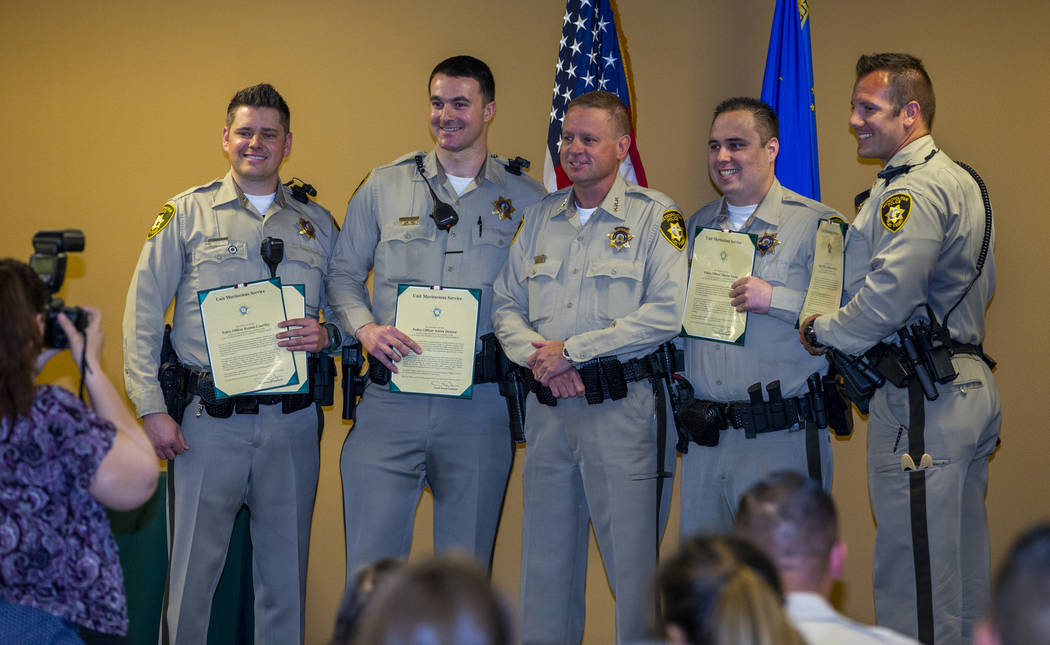 Officers receive a lifesaving and unit meritorious award from Undersheriff Kevin McMahill durin ...
