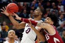 Auburn's forward Horace Spencer (0) and New Mexico State guard JoJo Zamora (4) battle for a reb ...