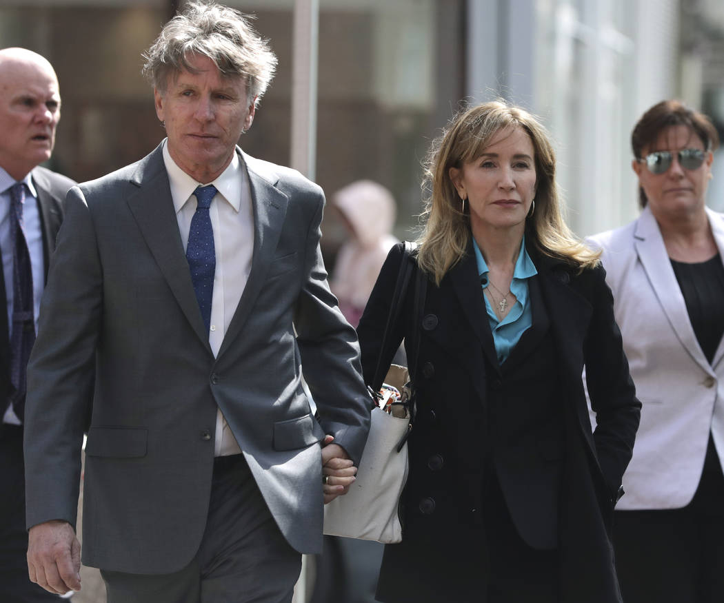 Actress Felicity Huffman arrives holding hands with an unidentified man, left, at federal court ...