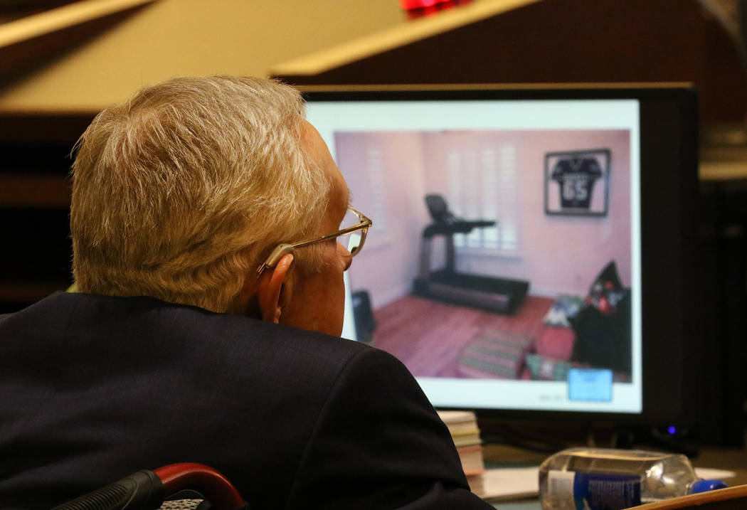 Former U.S. senator Harry Reid watches a photograph of his exercise room, that was displayed du ...