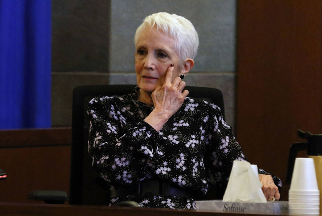 Former U.S. senator Harry Reid's wife Landra Gould points toward her left eye as she testifies ...