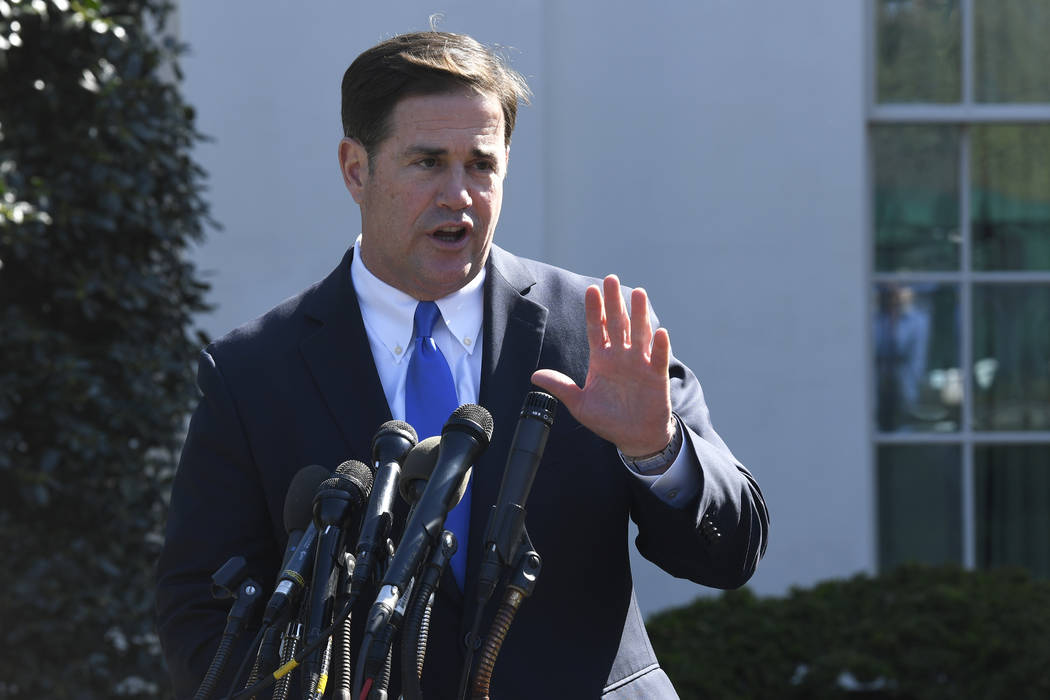 Arizona Gov. Doug Ducey talks to reporters outside the West Wing of the White House in Washingt ...