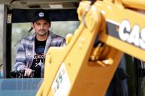Country music star Brad Paisley operates a backhoe as he breaks ground for The Store, a free gr ...