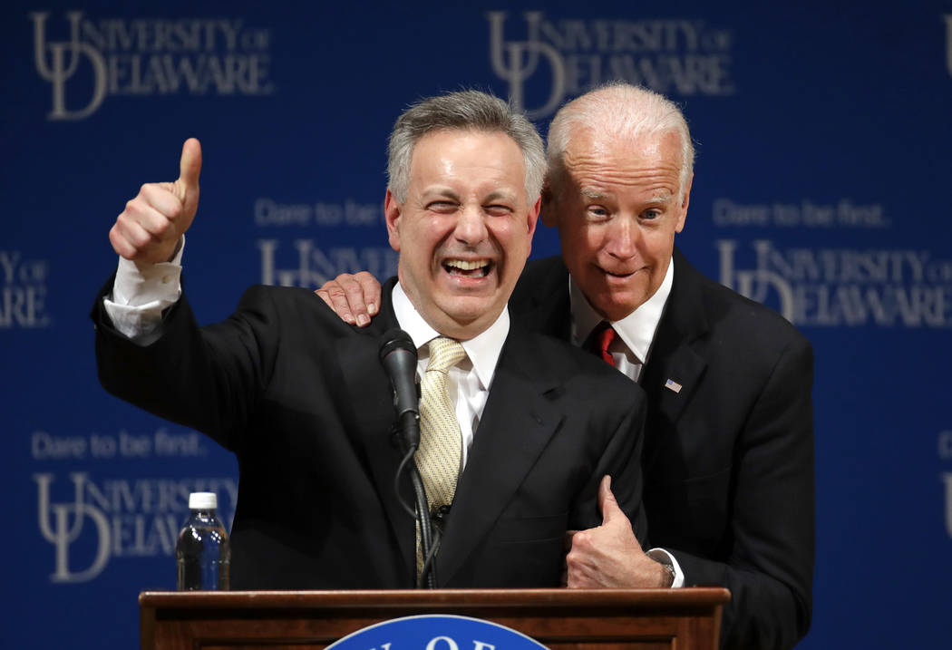 In this March 13, 2017, file photo, former Vice President Joe Biden, right, embraces University ...