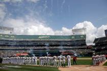 The Oakland Athletics and Los Angeles Angels watch fireworks during the national anthem prior t ...