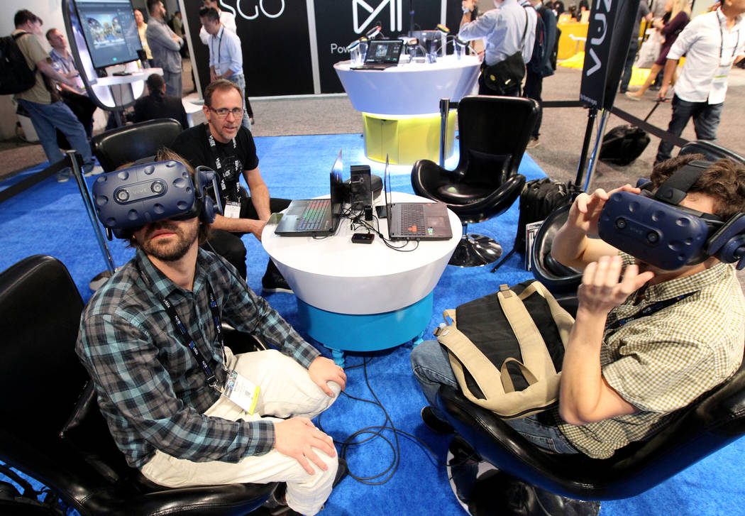 Matthew Celia of Light Sale VR, left, and Nathan Cohen of Florida State University check out vi ...