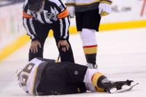 Vegas Golden Knights center Erik Haula (56) lies on the ice after taking a hit along the boards ...