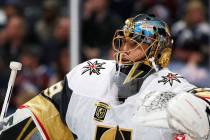 Vegas Golden Knights goaltender Marc-Andre Fleury leans on the top of the net during a time out ...