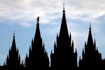 In this Jan. 3, 2018, file photo, the angel Moroni statue, silhouetted against the sky, sits at ...
