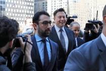 Tesla CEO Elon Musk, center, arrives at Manhattan Federal Court, in New York, Thursday, April 4 ...
