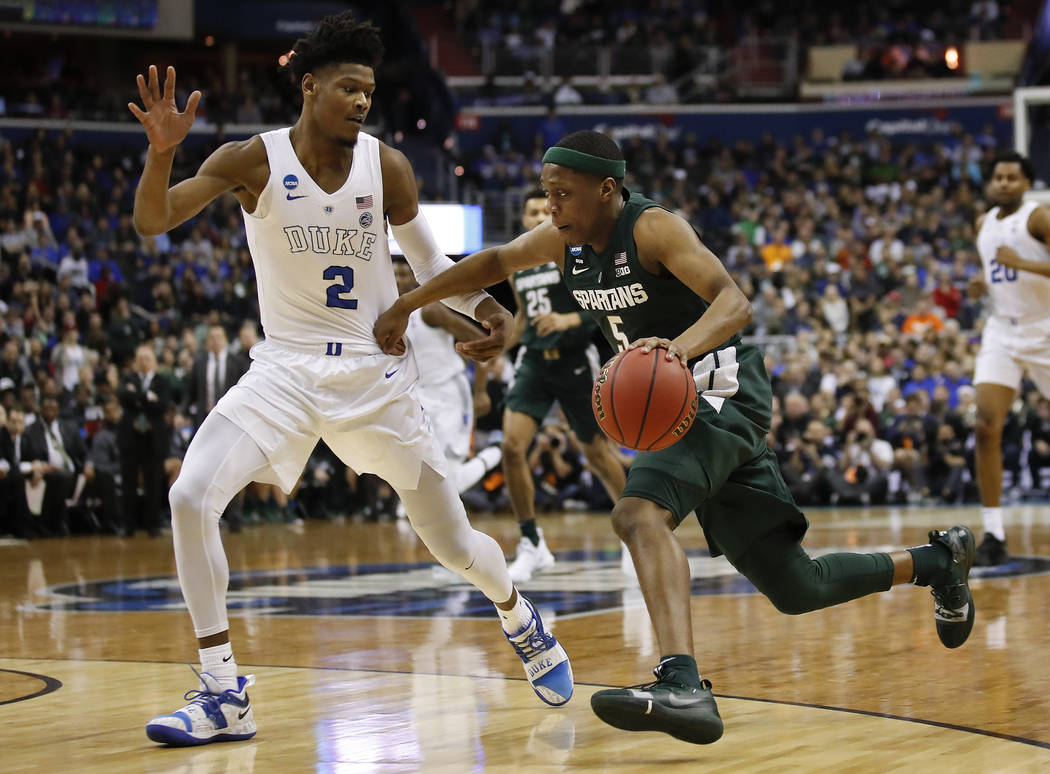 Michigan State guard Cassius Winston (5) drives past Duke forward Cam Reddish (2) during the fi ...