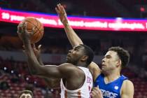 UNLV sophomore guard Amauri Hardy (3) drives past Air Force freshman guard Zach Couper (2) in t ...
