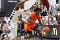 Bishop Gorman's Will McClendon (1) handles the ball against La Lumiere's Gerald Drumgoole in a ...