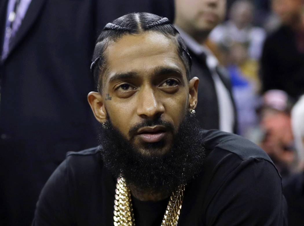 FILE - This March 29, 2018 file photo shows rapper Nipsey Hussle at an NBA basketball game betw ...