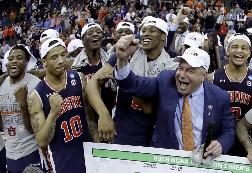 Auburn head coach Bruce Pearl celebrates with his team after the Midwest Regional final game ag ...