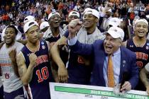 Auburn head coach Bruce Pearl celebrates with his team after the Midwest Regional final game ag ...