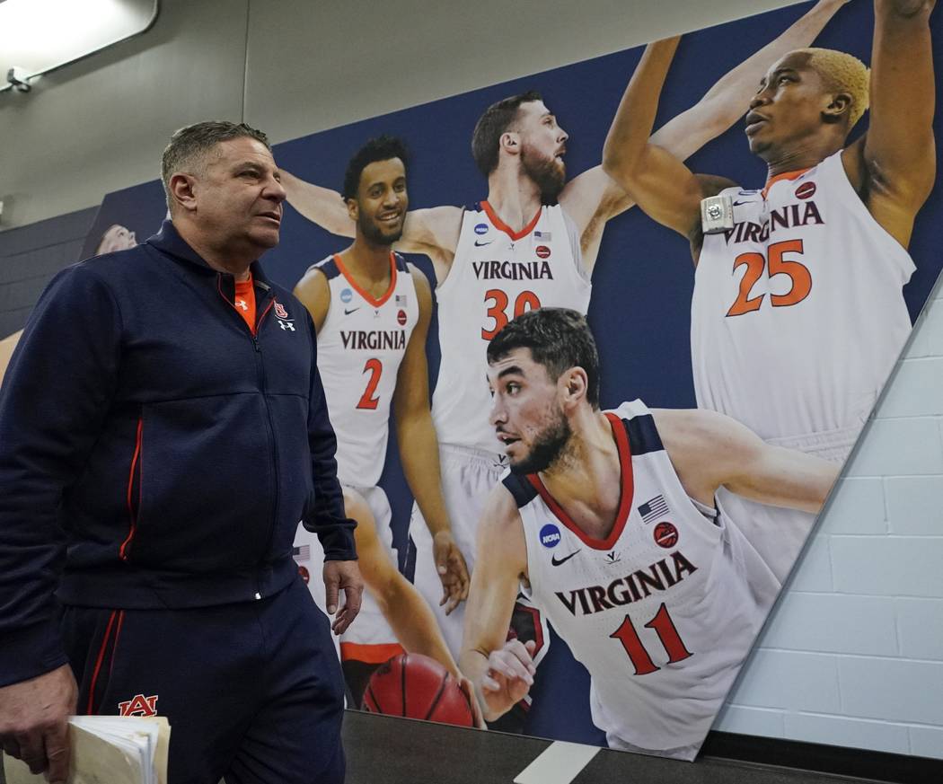 Auburn head coach Bruce Pearl walks to a news conference after a practice session for the semif ...