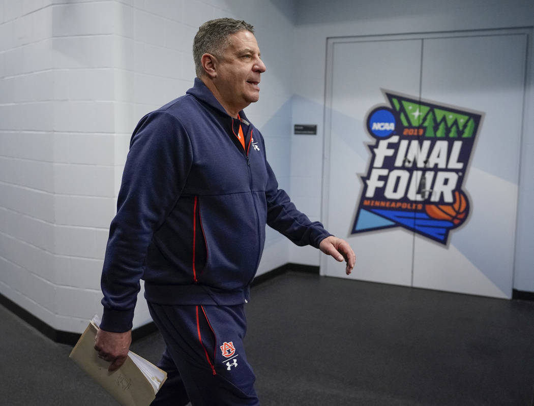 Auburn head coach Bruce Pearl walks to a news conference after a practice session for the semif ...