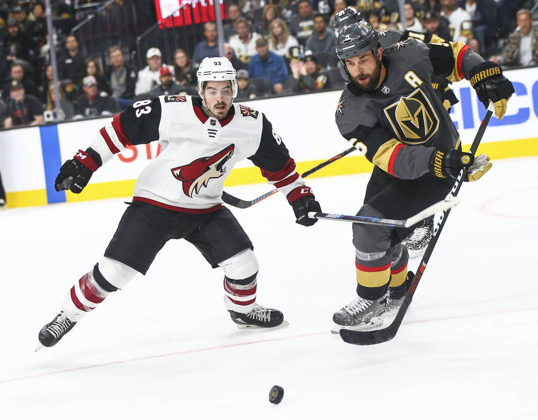 Golden Knights defenseman Deryk Engelland (5) and Arizona Coyotes right wing Conor Garland (83) ...