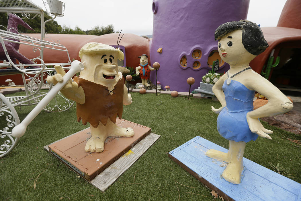 In this photo taken Monday, April 1, 2019, figurines of Barney and Betty Rubble stand outside t ...