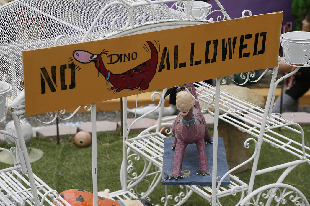 In this photo taken Monday, April 1, 2019, a figurine of Dino, the pet dinosaur, stands in a ca ...