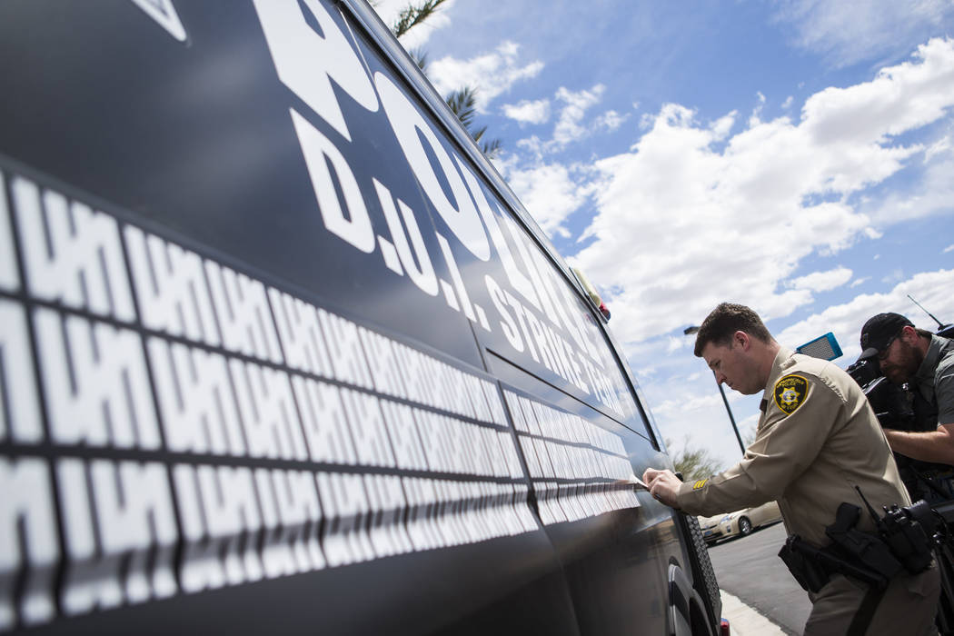 Metropolitan Police Department traffic officer Mike Thiele adds a marking to indicate 500 arres ...