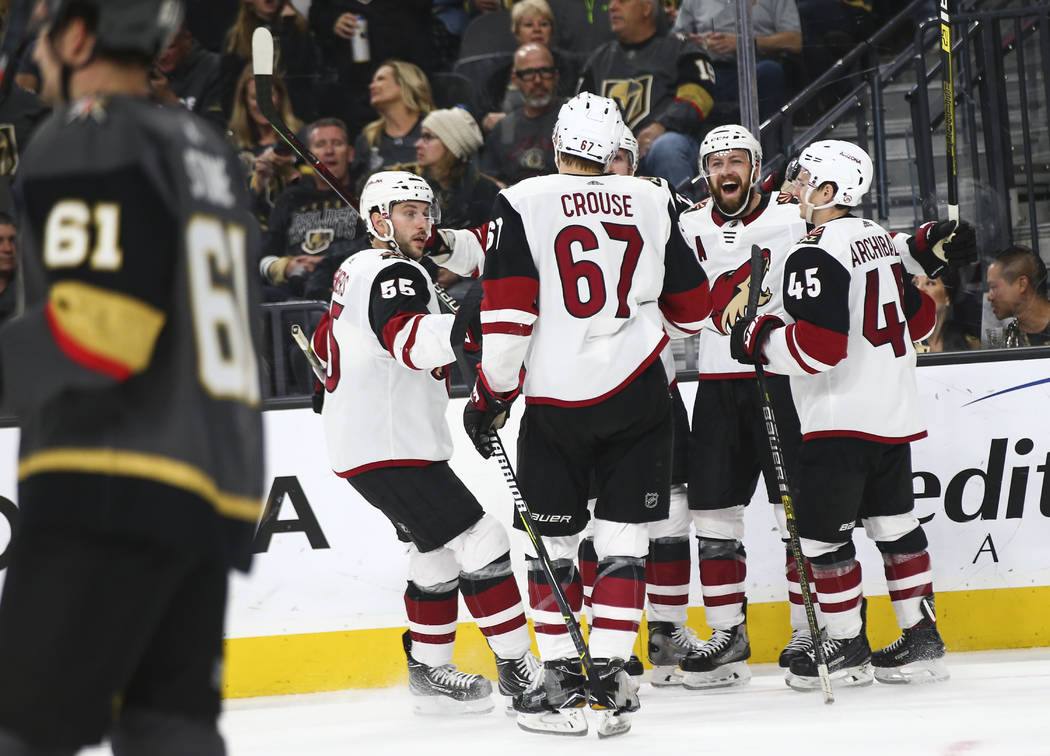 Arizona Coyotes players celebrate their third goal against the Golden Knights during the second ...