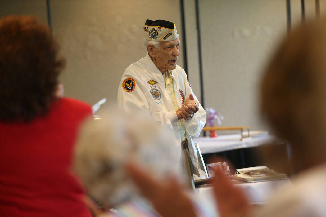 Pearl Harbor survivor Ed Hall watches as people applaud him after his speech dur ...