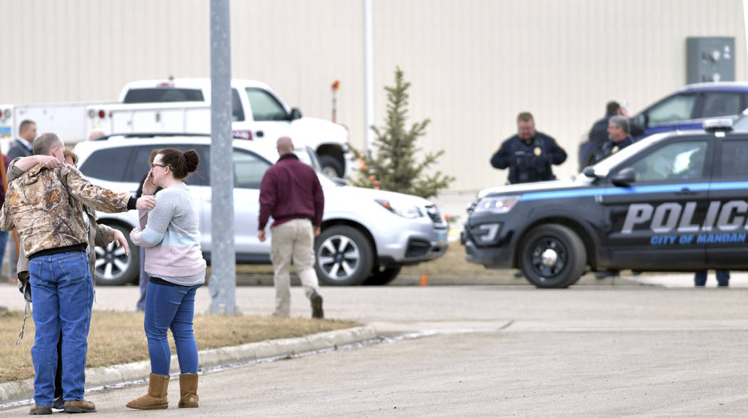 Family and friends console each other at the scene near the south side of the RJR Maintenance a ...