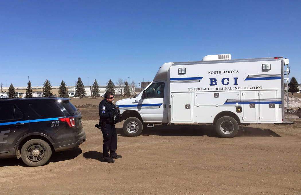 In this Wednesday, April 3, 2019 photo, state and local police search a field in Manton, N.D., ...