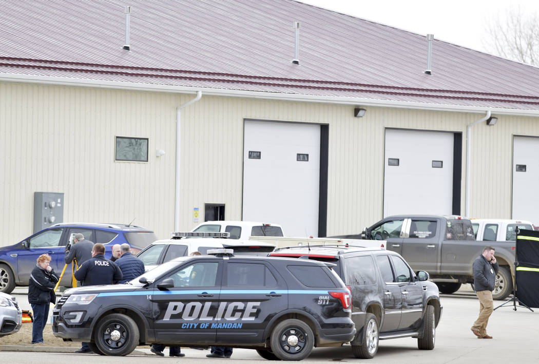 Mandan, N.D. Police Deputy Chief Lori Flaten, left, and other law enforcement personnel stand o ...