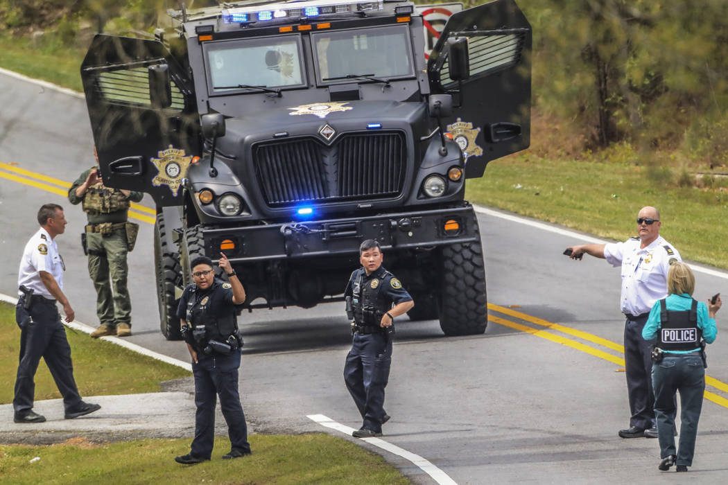 Clayton County police officers work a scene where a gunman reportedly shot a few Henry County p ...