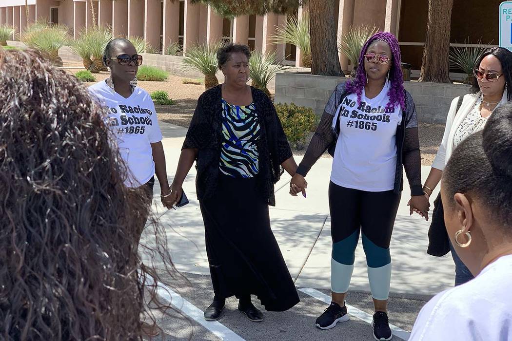 Mother Akiko Cooks, third right, prays outside the Clark County Juvenile Justice center in Las ...