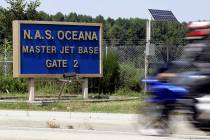 A motorcycle rider approaches the entrance to the Oceana Naval Air Station in Virginia Beach Va ...