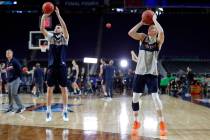 Virginia's Ty Jerome, left, and Kyle Guy shoot during a practice session for the semifinals of ...