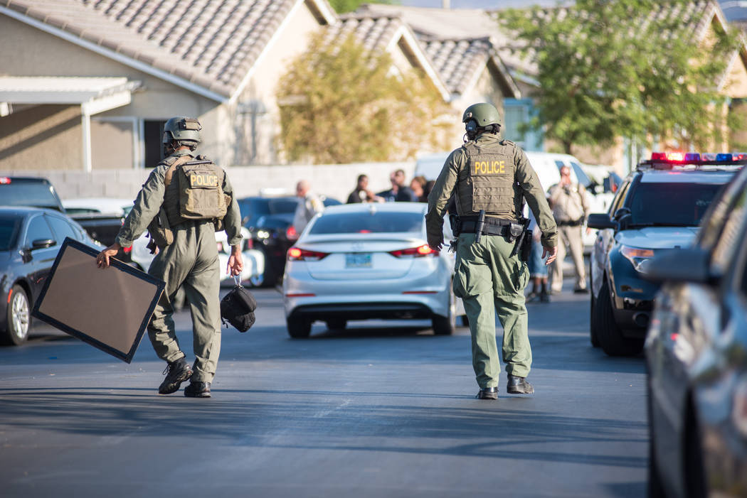 Las Vegas police respond to a burglary and shooting in a residential area near the Clark County ...