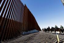Mounted Border Patrol agents ride along a newly fortified border wall structure on Oct. 26, 201 ...