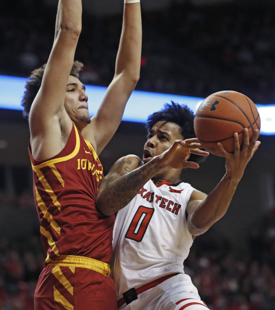 Texas Tech's Kyler Edwards (0) tries to shoot around Iowa State's George Conditt IV during the ...