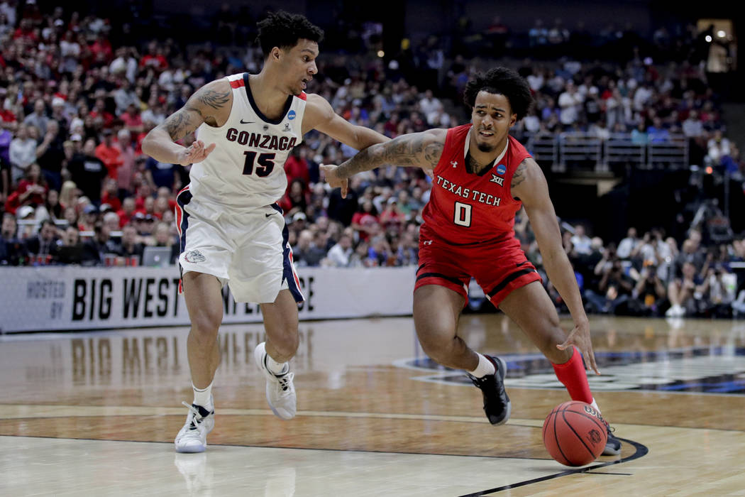Texas Tech guard Kyler Edwards drives to the basket around Gonzaga forward Brandon Clarke durin ...