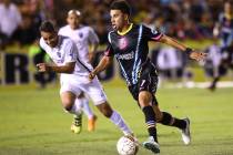 Las Vegas Lights FC midfielder Carlos Alvarez (7) moves the ball past San Antonio FC defender R ...
