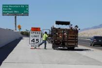 Cesar Escobar, traffic control supervisor for Las Vegas Paving Corporation, removes a work zone ...