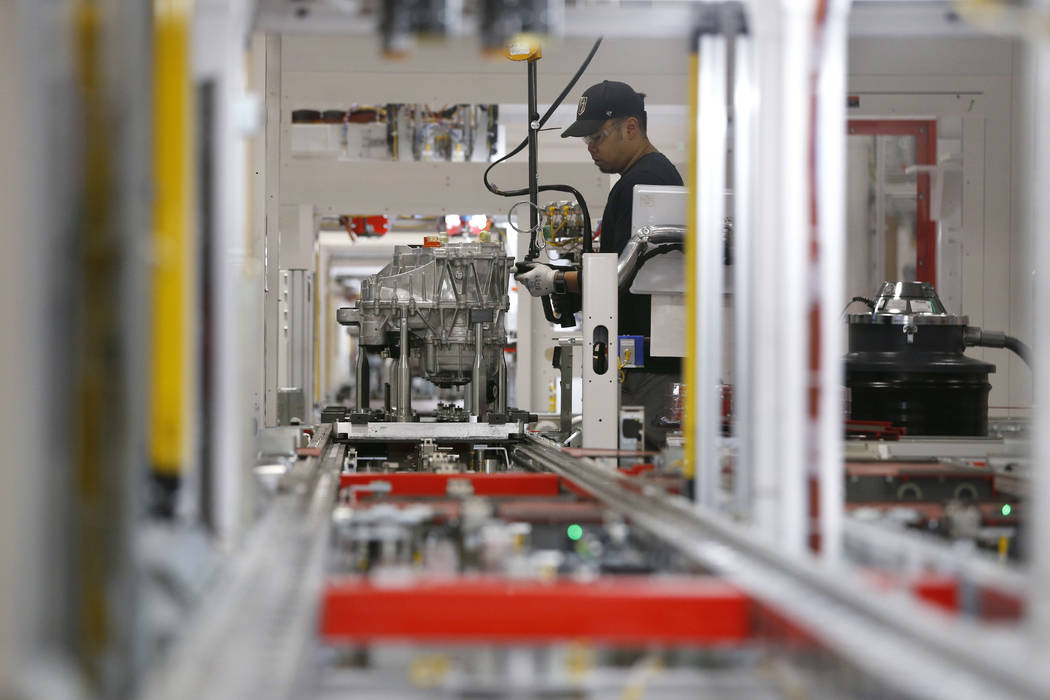 Kris Salcedo works on drive units at the Tesla Gigafactory, east of Reno, Nev., on Tuesday, Dec ...