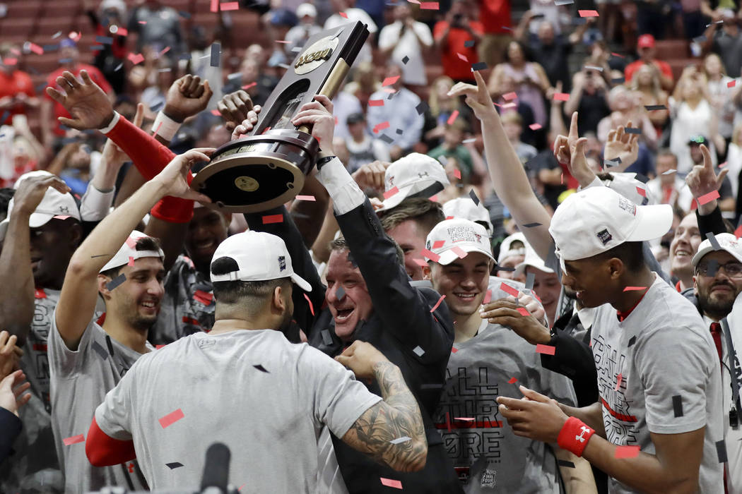 Texas Tech coach Chris Beard celebrates with the trophy after the team's win over Gonzaga durin ...